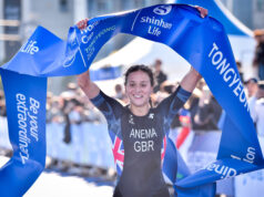 Tilly Anema dominates Tongyeong for her first World Cup victory Woman in black tri suit and dark hair lifts blue finish tape aloft
