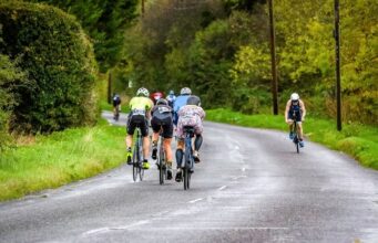 A group of cyclists on a country road