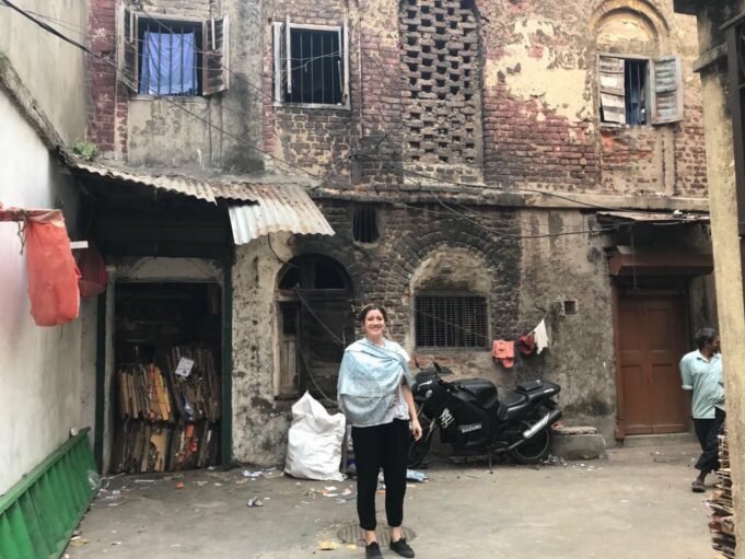 Photo of woman in front of an Indian home