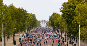 Runners running along The Mall with Buckingham Palace in the distance