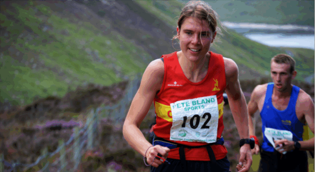 Jasmin Paris MBE named Brathay Trust Patron A woman in a red club vest and a race number runs uphill