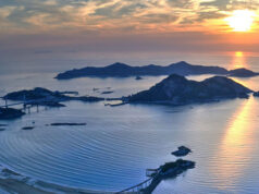 A dreamy sunrise photo of islands in a blue sea