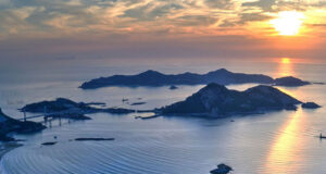 A dreamy sunrise photo of islands in a blue sea