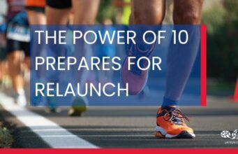 White text overlays an image of runners in a road race. The Power of 10 prepares for relaunch
