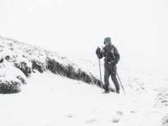 The 2026 Montane Winter Spine Race returns A lone man with poles and wearing full winter kit is alone in a snowy landscape