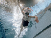 Lucy Charles-Barclay is back after surgery A woman swims in a pool. Shot taken from the pool bottom, looking up as woman swims over camera.