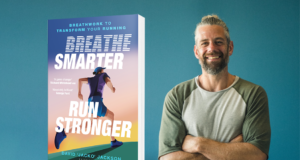 A man on the right of the picture smiles and looks at the camera, his arms folded. On the left is an image of the book Breathe Smarter, Run Stronger