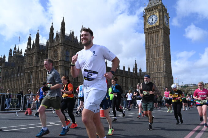 London Landmarks Runners on a busy London street next to Elizabeth Tower and the Houses of Parliament