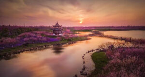 An ethereal riverside landscape with a Chinese Temple
