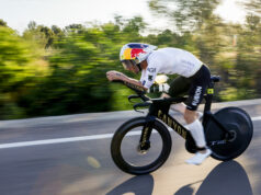 Male athlete on bike. Background is blurred as he's moving so fast.