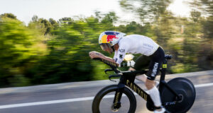Male athlete on bike. Background is blurred as he's moving so fast.