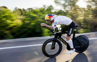Male athlete on bike. Background is blurred as he's moving so fast.