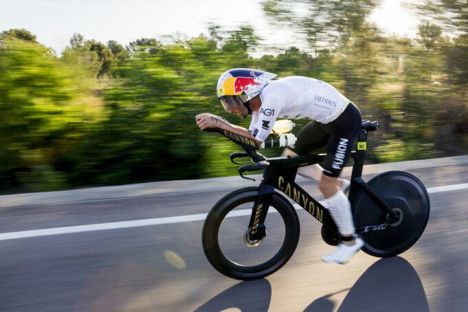 Male athlete on bike. Background is blurred as he's moving so fast.