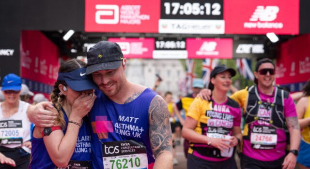 A man and woman hug as they cross the finish finish line