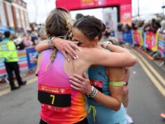 Women’s course record broken at Barry Island 10K Two female runners hug beyond the finish gantry