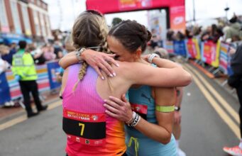 Women’s course record broken at Barry Island 10K Two female runners hug beyond the finish gantry