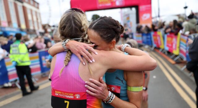 Women’s course record broken at Barry Island 10K Two female runners hug beyond the finish gantry
