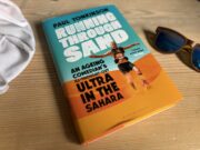 Running Through Sand: we can still do hard things Book and sunglasses on a wooden table