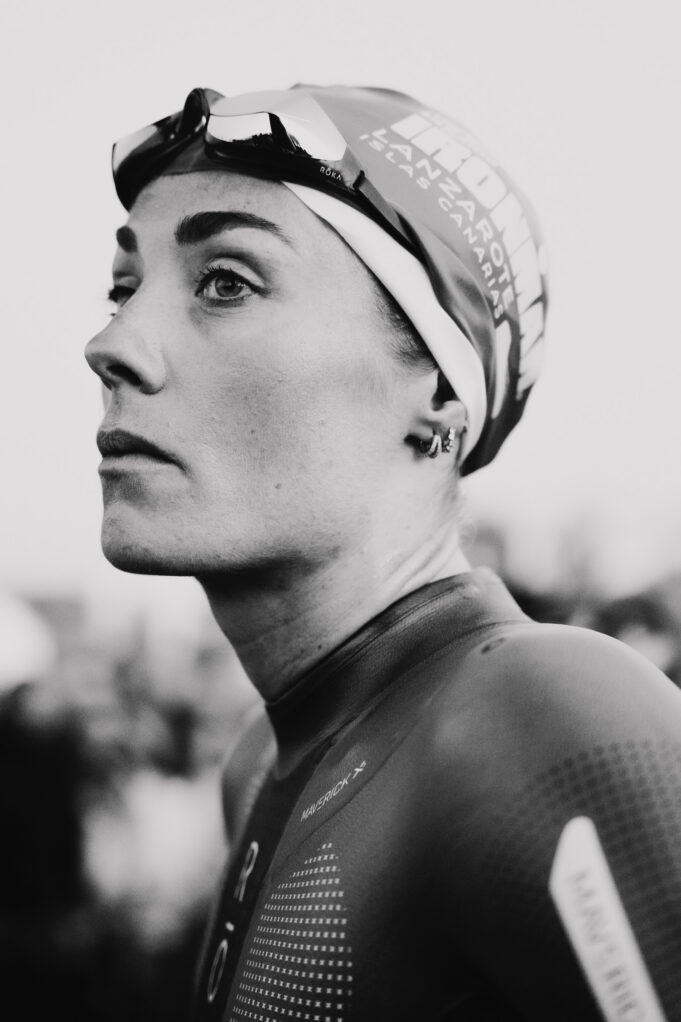 Lucy Charles-Barclay Black and whiite image of a head and shoulders shot of woman in a wetsuit with goggles and swimcap on head