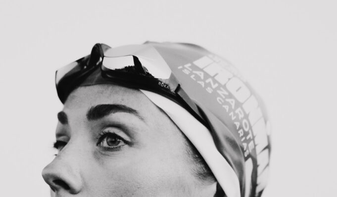 Lucy Charles-Barclay returns 16 weeks after surgery Black and whiite image of a head and shoulders shot of woman in a wetsuit with goggles and swimcap on head