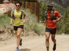 Artilect Sprint Tee Review A male and female runner each wear a red and yellow t-shirt respectively, black shorts and a race vest.