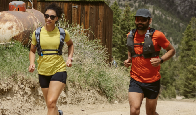 Artilect Sprint Tee Review A male and female runner each wear a red and yellow t-shirt respectively, black shorts and a race vest.