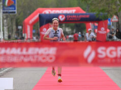 Solok and Theunissen claim victory at Challenge Cesenatico Female triathlete runs towards a red finish tape