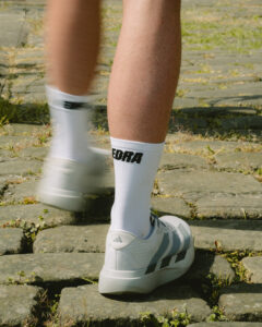 A runner wears white socks and white trainers