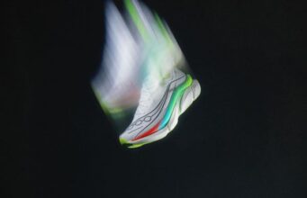 Arty shot of a white running shoe moving so fast it looks like it has Hermes wings