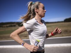 McColgan tackles gender gap in sports science Woman in white tshirt running along a road in what looks like a hot, sparse landscape. She's carrying a SiS gel