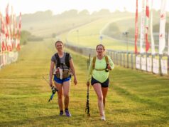 Thousands take on London to Brighton in heatwave Two female walkers on the finish straight. The sun is low in the sky