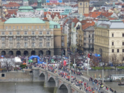 Many runners on a bridge over a river
