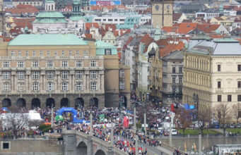 Many runners on a bridge over a river