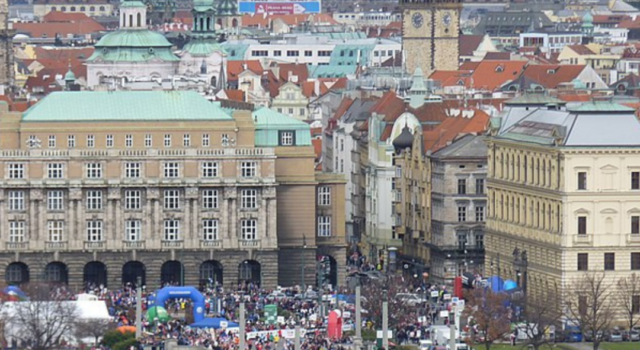 Many runners on a bridge over a river