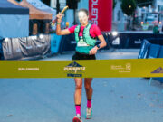 Woman runs towards a finish line
