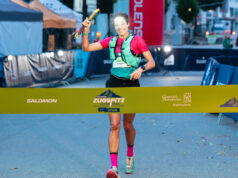Woman runs towards a finish line