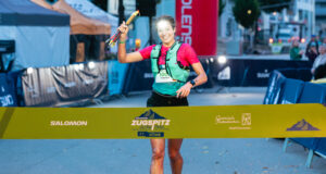 Woman runs towards a finish line