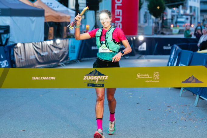 Woman runs towards a finish line