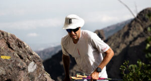Man with poles passes through a high mountain gap