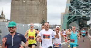 Runners with the Tyne Bridge behind them