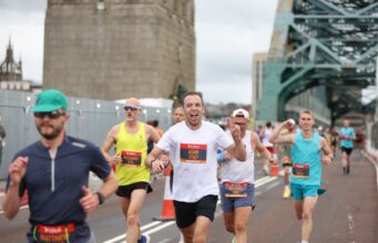 13,000 runners at biggest ever Great North 10K Runners with the Tyne Bridge behind them