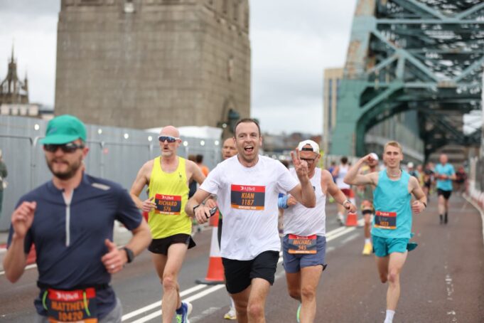 Runners with the Tyne Bridge behind them