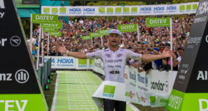 Man runs through finish tape, he looks emotional
