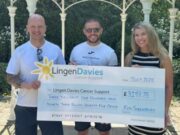 Lingen Davies takes on Shrewsbury Half and Metric Half Two men and a woman hold a giant cheque