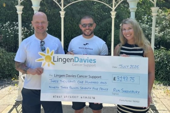 Lingen Davies takes on Shrewsbury Half and Metric Half Two men and a woman hold a giant cheque