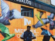 Merrell and Ollie Olanipekun inspire Londoners to explore nature Man stands i front of building painted with birds