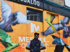 Merrell and Ollie Olanipekun inspire Londoners to explore nature Man stands i front of building painted with birds