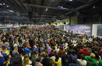 Hodgkinson and McColgan headline National Running Show Hundreds of people sit in front of a large stage listening to a speaker