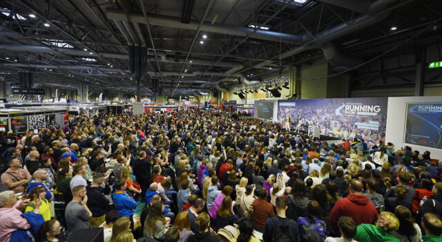 Hodgkinson and McColgan headline National Running Show Hundreds of people sit in front of a large stage listening to a speaker