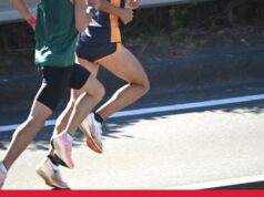 Team GB&NI: World Athletics Road Running Two male athletes in shorts and vest run on a road. Their heads are not visible.